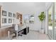 Bright home office featuring built-in shelving, a modern desk, and a large window with natural light at 5910 Gulf Of Mexico Dr, Longboat Key, FL 34228