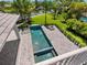 Backyard pool featuring an integrated jacuzzi, fountains, and a fire pit at 5910 Gulf Of Mexico Dr, Longboat Key, FL 34228