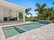Outdoor kitchen and pool area with a spa and water features at 5910 Gulf Of Mexico Dr, Longboat Key, FL 34228