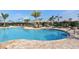 Enjoy this community pool with lounge chairs, sunshades, beautiful landscaping, and clear blue water for relaxation at 6771 Wild Lake Ter, Bradenton, FL 34212