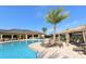 Relax by the community pool featuring lounge chairs, a sunshade and lush landscaping to create a resort-like ambiance at 6771 Wild Lake Ter, Bradenton, FL 34212