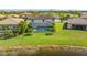 Aerial view of home with pool and backyard, near lake at 6771 Wild Lake Ter, Bradenton, FL 34212