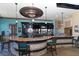 Community bar with granite countertop and teal stools at 6771 Wild Lake Ter, Bradenton, FL 34212