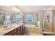 Large bathroom with double vanity, soaking tub, and walk-in shower at 6771 Wild Lake Ter, Bradenton, FL 34212