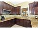 Community kitchen with granite countertops and dark wood cabinets at 6771 Wild Lake Ter, Bradenton, FL 34212