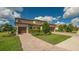 Two-story house with tile roof, two-car garage, and lush landscaping at 6771 Wild Lake Ter, Bradenton, FL 34212