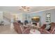 Living room with a fireplace, large TV and comfortable seating at 6771 Wild Lake Ter, Bradenton, FL 34212