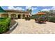 Community patio with tables and chairs, surrounded by landscaping at 6771 Wild Lake Ter, Bradenton, FL 34212