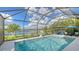 Inviting screened pool and patio overlooking a lake at 6771 Wild Lake Ter, Bradenton, FL 34212