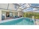 Enclosed pool with patio furniture and views of the home and backyard at 6771 Wild Lake Ter, Bradenton, FL 34212