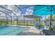 Relaxing pool area with patio furniture and lake view at 6771 Wild Lake Ter, Bradenton, FL 34212