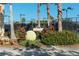 Tennis center with large tennis ball and landscaping at 6771 Wild Lake Ter, Bradenton, FL 34212