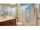 This bathroom has a shower and tub combination and wood cabinets at 7407 Sea Island Ln, Bradenton, FL 34201