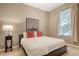 This bedroom features a neutral color palette, a comfortable bed, and a window with natural light at 7407 Sea Island Ln, Bradenton, FL 34201