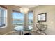 Breakfast nook with tranquil lake views, modern lighting, and a glass table at 7407 Sea Island Ln, Bradenton, FL 34201