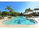 Inviting community pool with palm trees and a water slide at 7407 Sea Island Ln, Bradenton, FL 34201