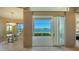 Dining area with sliding doors leading to a screened lanai overlooking the lake at 7407 Sea Island Ln, Bradenton, FL 34201