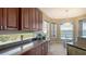 This is a beautiful kitchen with wood cabinets, granite countertops, and a dining area with a water view at 7407 Sea Island Ln, Bradenton, FL 34201