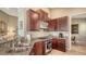 Modern kitchen with granite countertops, stainless steel appliances, and dark wood cabinetry at 7407 Sea Island Ln, Bradenton, FL 34201