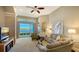 Bright living room with lake view access, featuring comfy seating and large windows at 7407 Sea Island Ln, Bradenton, FL 34201