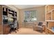 This home office features built-in shelving, a desk, and a comfortable chair at 7407 Sea Island Ln, Bradenton, FL 34201