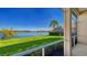 Screened lanai offering tranquil water views, lush landscaping, and sunny skies at 7407 Sea Island Ln, Bradenton, FL 34201