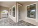 Covered balcony with arched windows and tiled floor at 7634 Windy Hill Cv, Bradenton, FL 34202