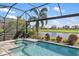 Screened pool and spa overlooking a golf course and lake at 7634 Windy Hill Cv, Bradenton, FL 34202