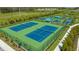 Well-maintained tennis courts with surrounding landscaping at 8124 Anthirium Loop, Sarasota, FL 34240