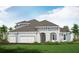 Two-story home with three car garage and landscaped yard at 8124 Anthirium Loop, Sarasota, FL 34240