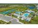 Aerial view of community amenities including pools, tennis courts, playground at 8124 Anthirium Loop, Sarasota, FL 34240