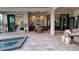 Relaxing outdoor patio with a spa, dining area, and kitchen at 1018 Blue Shell Loop, Sarasota, FL 34240