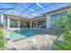 Inviting swimming pool with a covered patio and outdoor kitchen at 1018 Blue Shell Loop, Sarasota, FL 34240