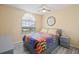 Bedroom with gray dresser, ceiling fan, and colorful quilt at 1228 50Th E St, Bradenton, FL 34208