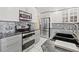 Modern kitchen featuring stainless steel appliances and gray cabinets at 1228 50Th E St, Bradenton, FL 34208