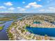 Stunning aerial view of waterfront home, showcasing landscaping and waterfront access at 1228 50Th E St, Bradenton, FL 34208