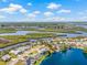 Aerial view featuring a waterfront home with an enclosed pool, and waterway views at 1228 50Th E St, Bradenton, FL 34208
