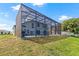 Spacious backyard with screened patio and lush green grass at 1228 50Th E St, Bradenton, FL 34208