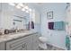 Bathroom with granite vanity, grey cabinets, and decorative mirror at 1228 50Th E St, Bradenton, FL 34208