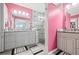 Modern bathroom featuring dual vanities, glass shower, and contemporary decor at 1228 50Th E St, Bradenton, FL 34208