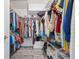Walk-in closet with wood-look floors, built-in shelving, and ample space for storage at 1228 50Th E St, Bradenton, FL 34208