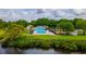 Community pool, playground and recreational area surrounded by lush landscaping, offering a relaxing and fun atmosphere at 1228 50Th E St, Bradenton, FL 34208