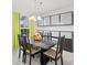 Bright dining room with elegant chandelier, decorative storage and a view from the window at 1228 50Th E St, Bradenton, FL 34208