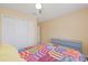 Bedroom with gray dresser, ceiling fan and colorful quilt at 1228 50Th E St, Bradenton, FL 34208