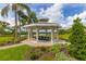Picturesque gazebo with seating and manicured landscaping in a tranquil common area near the water at 1228 50Th E St, Bradenton, FL 34208