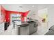 Modern kitchen with granite countertops, stainless steel appliances, and a view of the backyard at 1228 50Th E St, Bradenton, FL 34208