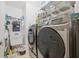 Laundry room with washer, dryer, utility sink, storage shelves and supplies at 1228 50Th E St, Bradenton, FL 34208