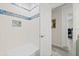 Tiled shower with a built-in seat and niche for storage, complemented by a door leading outside at 1228 50Th E St, Bradenton, FL 34208