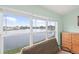 Bedroom with lake view from large windows and comfy couch at 1228 50Th E St, Bradenton, FL 34208