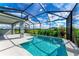 Inviting screened pool and patio with a waterfall feature, providing a relaxing outdoor space at 12389 Cedar Pass Trl, Parrish, FL 34219